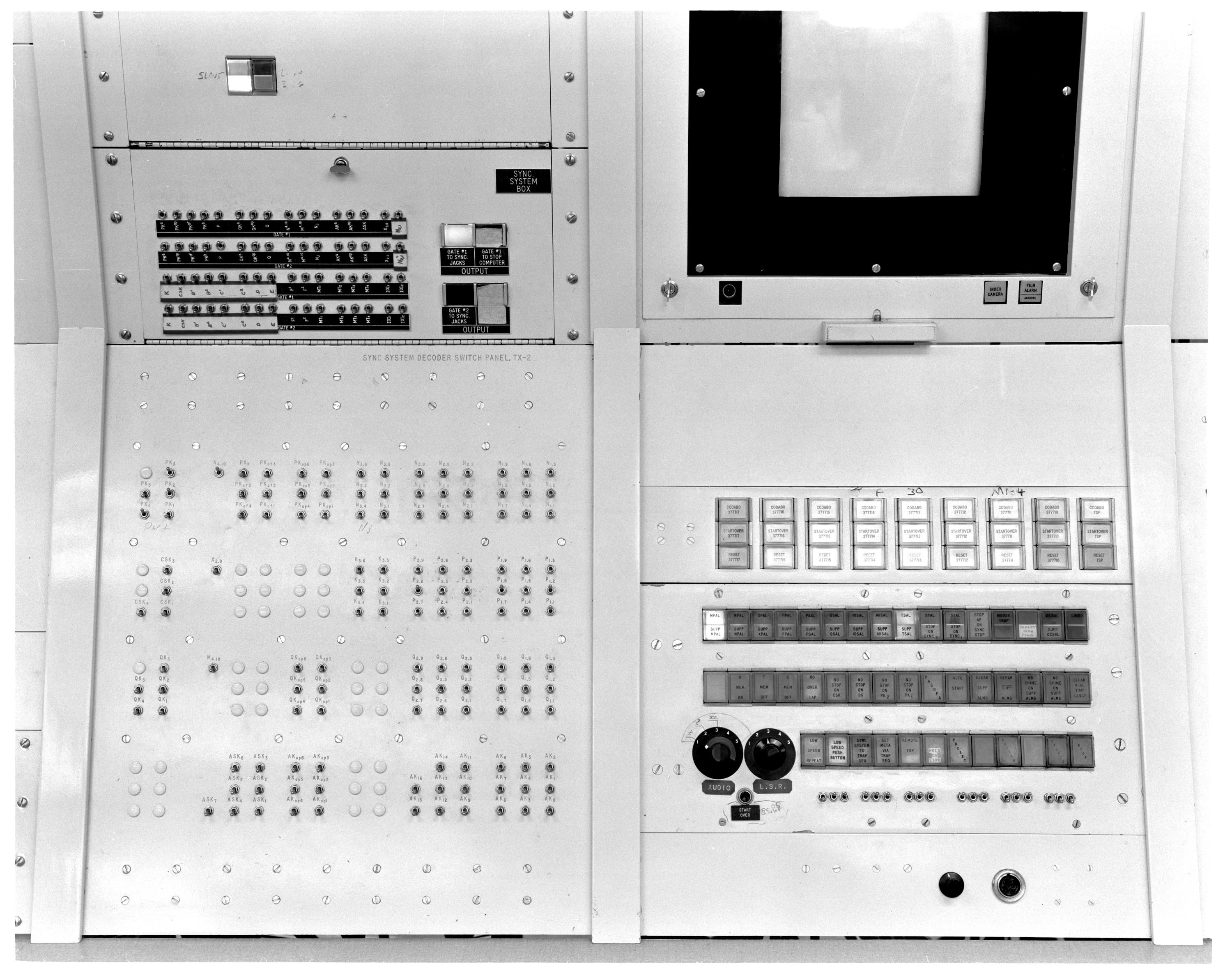 P91-215: 02/28/1963, A Cropped version of this photo, showing the
right side of the photo, appears is in: "TX-2 Users Handbook," Lincoln
Manual No. 45, July, 1961, p. 5-11, Figure 5-5.: Alarms, conditions
and Action Pushbuttons. [same photo also appears on pp. 5-16 and
5-18]; A Cropped version of this photo, showing the left side of the
photo, appears in: "TX-2 Users Handbook," Lincoln Manual No. 45, July,
1961, p. 5-21, Figure 5-9.: TX-2 Sync
System.